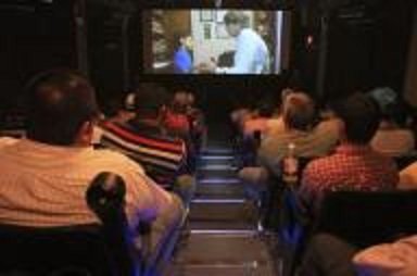Trabajadores de la petrolera estatal Pemex observan una película para promover la seguridad en un teatro móvil en Ciudad del Carmen, México