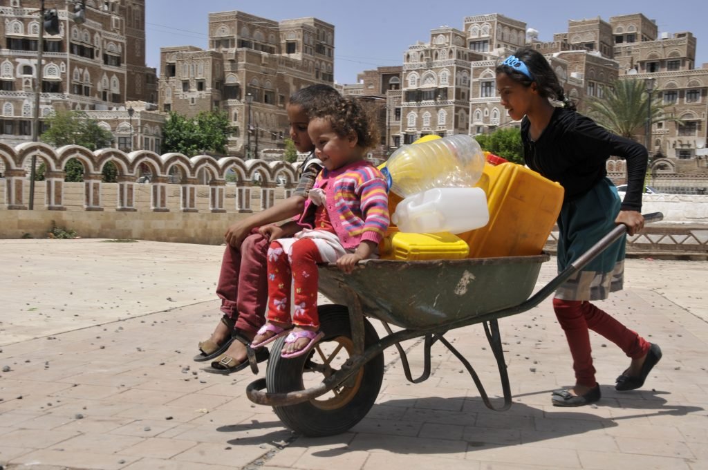 On 11 May, a girl pushes two younger children  a boy and a girl  in a wheelbarrow that also bears several jerrycans in Sanaa, the capital. By 12 May 2015 in Yemen, escalating conflict continued to exact a heavy toll on children and their families. Some 300,000 people have been internally displaced. Casualties have reached 1,527, including 115 children, and 6,266 people have been injured, including 172 children. Prior to the current crisis, 15.9 million people  including 7.9 million children  were already in need of humanitarian assistance. Despite the challenging operating conditions, UNICEF is scaling up its humanitarian response, including in the areas of nutrition, water, sanitation and hygiene (WASH), health, child protection and education. Support since the start of the current conflict has included providing access to clean water to 604,360 people and access to antenatal, delivery and postnatal care to 3,386 pregnant women; distributing hygiene kits to 16,662 families; and sharing educational messaging on health, hygiene and protection to 38,000 people. UNICEF has appealed for US$88.1 million to cover these and other responses through December 2015; 87 per cent remains unfunded to date.