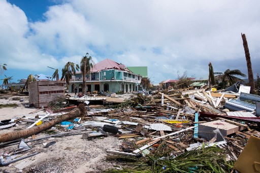 A photo taken on September 7, 2017 shows damage in Orient Bay on the French Carribean island of Saint-Martin, after the passage of Hurricane Irma. France, the Netherlands and Britain on September 7 rushed to provide water, emergency rations and rescue teams to territories in the Caribbean hit by Hurricane Irma, with aid efforts complicated by damage to local airports and harbours. The worst-affected island so far is Saint Martin, which is divided between the Netherlands and France, where French Prime Minister Edouard Philippe confirmed four people were killed and 50 more injured. / AFP PHOTO / Lionel CHAMOISEAU